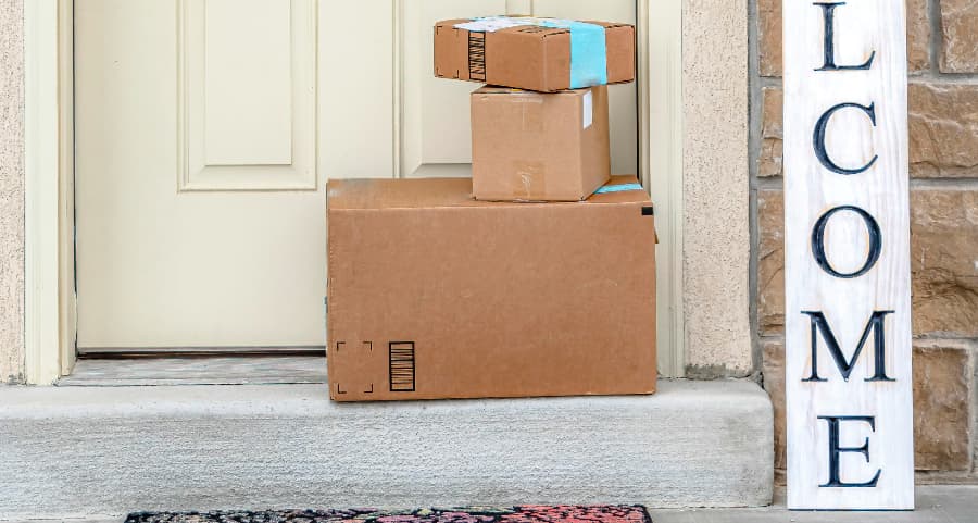 Boxes by the door of a residence with a welcome sign in McAllen